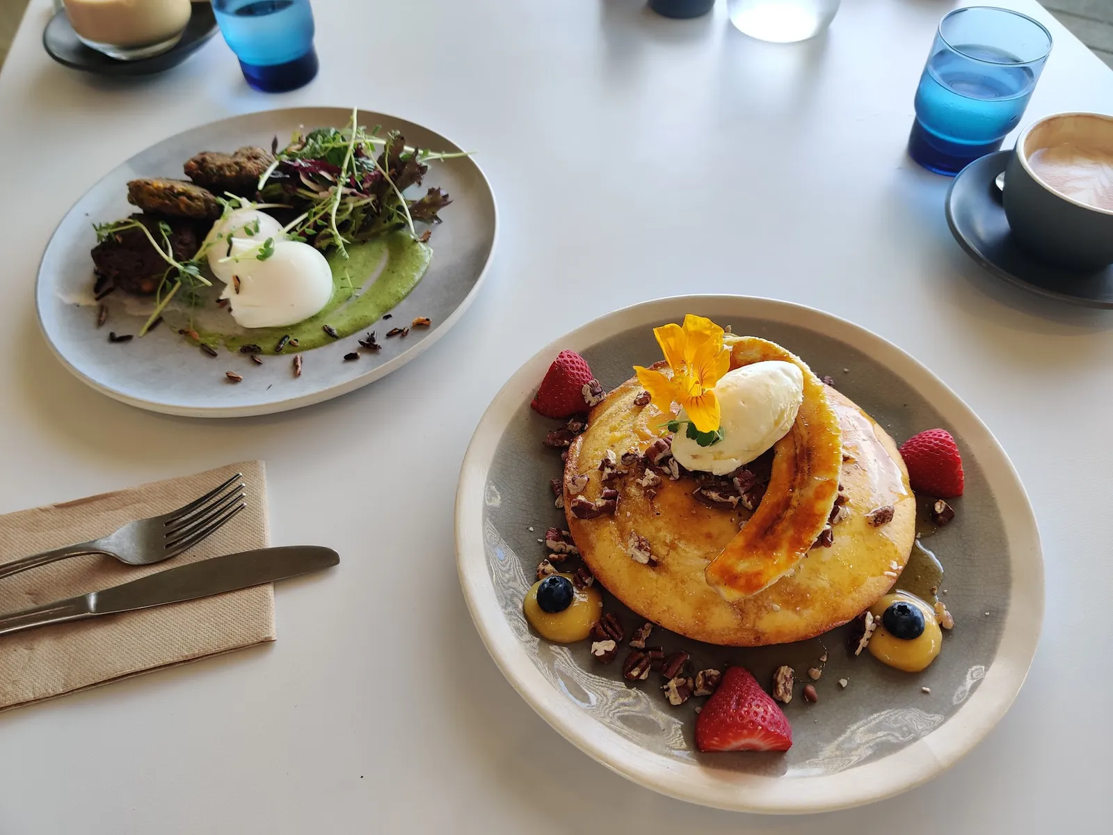 Cape Kitchen breakfast spread: zucchini fritter with poached egg and ricotta hotcakes with banana